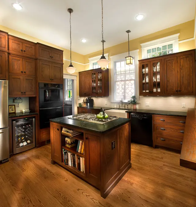 Craftsman-style kitchen renovation with quartersawn oak cabinetry and a bookshelf island